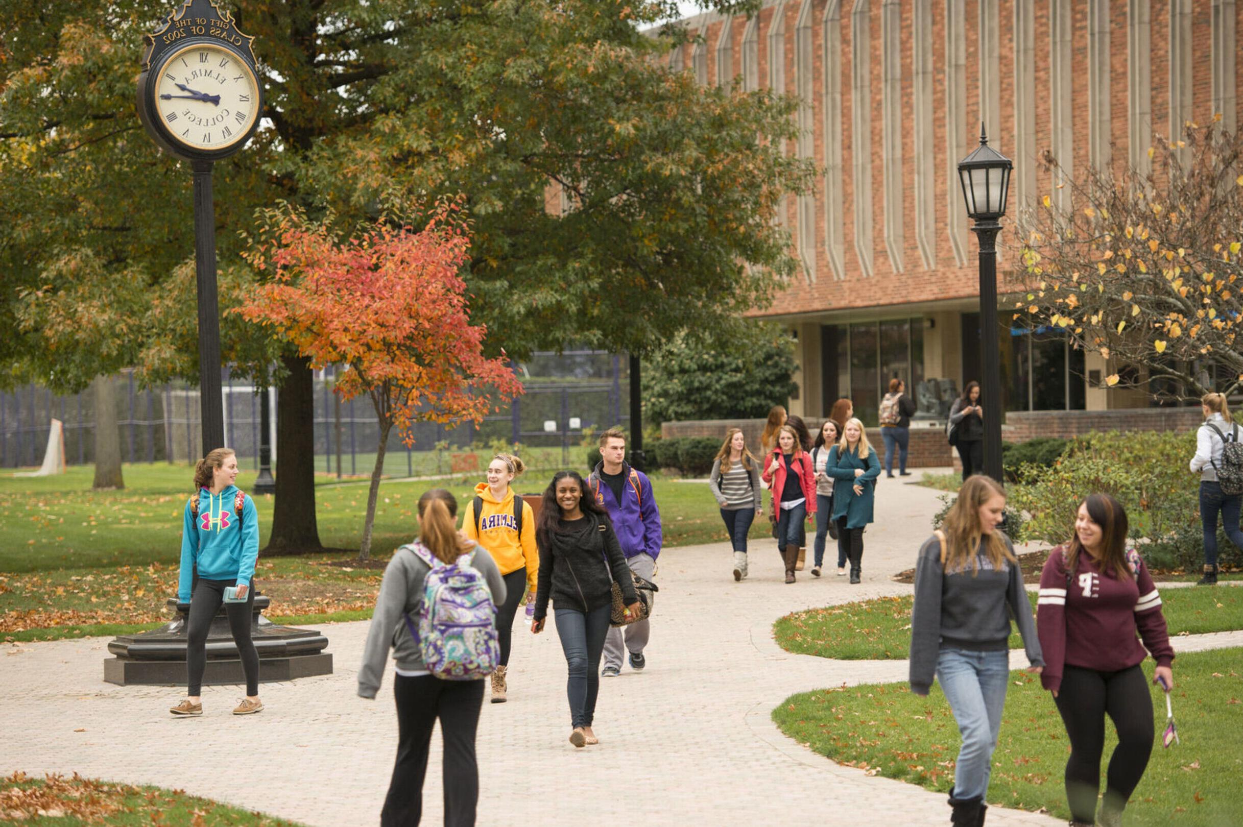 Students walk on campus during the fall