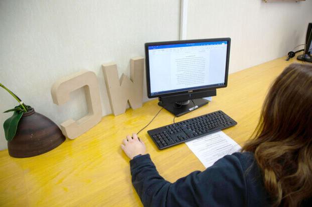 A student works on a writing project on a computer in the Writing Center